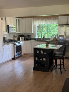 Kitchen with an island — cabinets, glass and floors.
